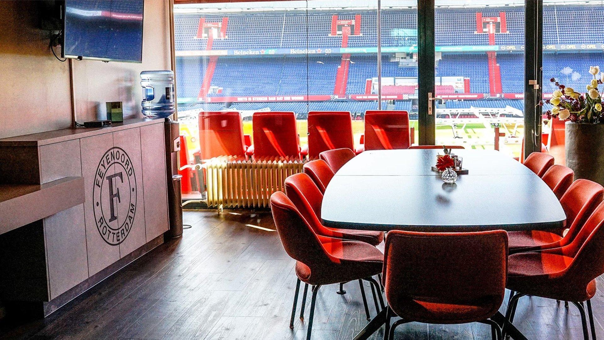 a table and chairs in a room with a large window